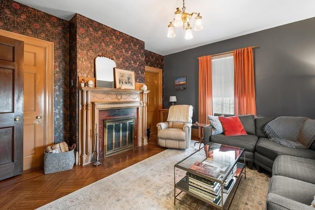 living room with an inviting chandelier, a premium fireplace, and wallpapered walls