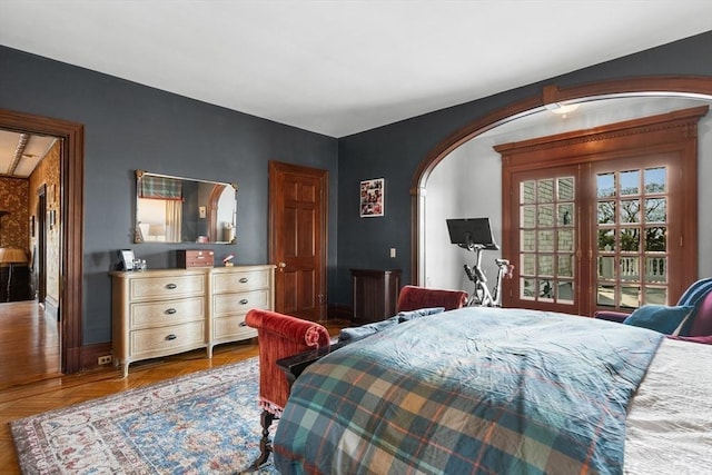 bedroom with access to exterior and arched walkways