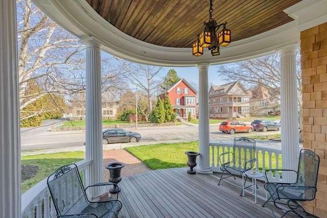 wooden terrace with a residential view and covered porch