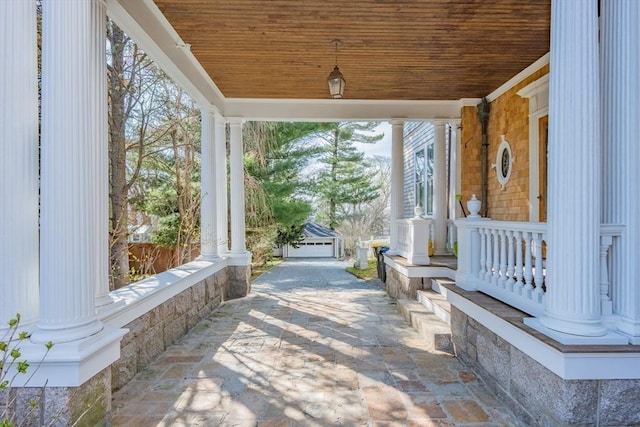 view of patio with an outbuilding and covered porch