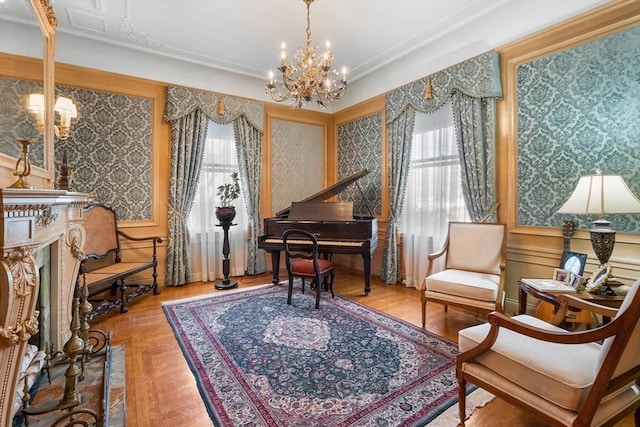 sitting room featuring crown molding, a chandelier, a high end fireplace, and wallpapered walls