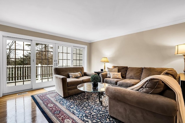 living room featuring hardwood / wood-style flooring and ornamental molding