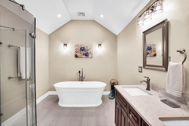 bathroom featuring shower with separate bathtub, vanity, and lofted ceiling