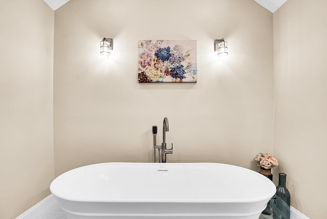 bathroom featuring tile patterned floors and a tub