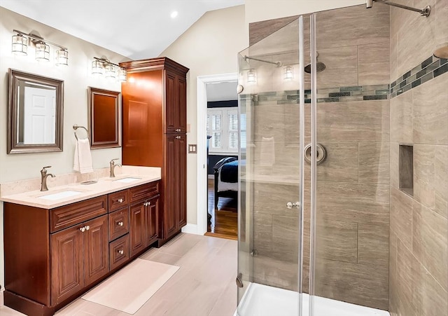 bathroom featuring tile patterned floors, lofted ceiling, vanity, and an enclosed shower