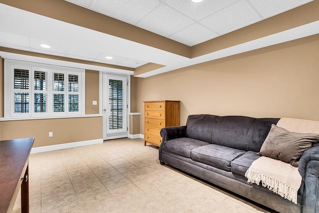 living room with a drop ceiling