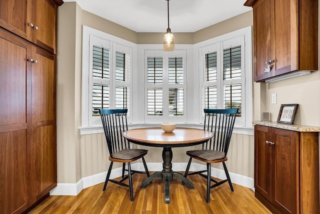 dining area with a healthy amount of sunlight and light hardwood / wood-style floors