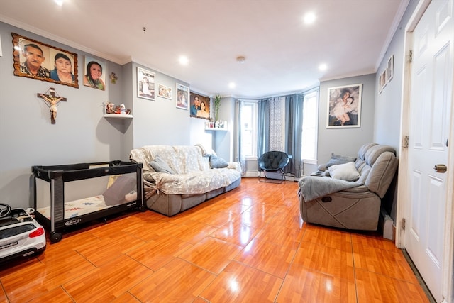 sitting room with wood-type flooring and ornamental molding