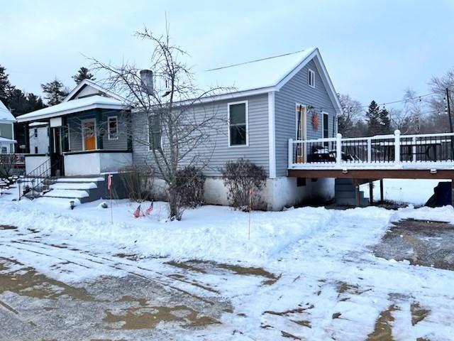 view of front facade with a wooden deck