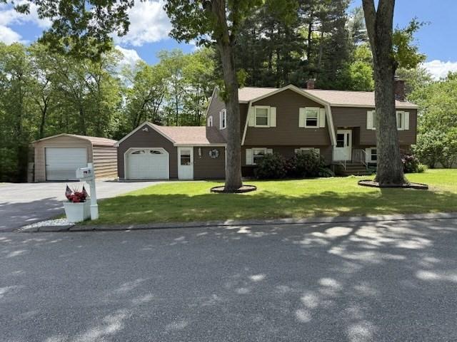 75 I St, Dracut, MA 01826 - bi-level home with a gambrel roof, a front yard, a garage, and asphalt driveway