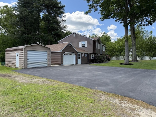 75 I St, Dracut, MA 01826 - view of front of house featuring a front lawn, roof with shingles, and driveway