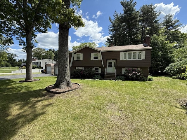 75 I St, Dracut, MA 01826 - split foyer home featuring a chimney, entry steps, and a front yard