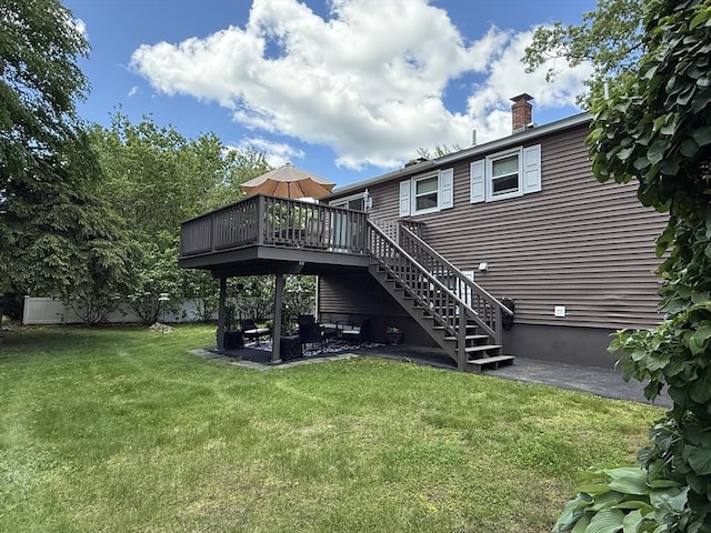 75 I St, Dracut, MA 01826 - back of property with a wooden deck, a lawn, a patio area, stairs, and a chimney