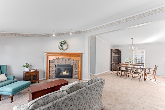 carpeted living room with crown molding, a notable chandelier, and a fireplace