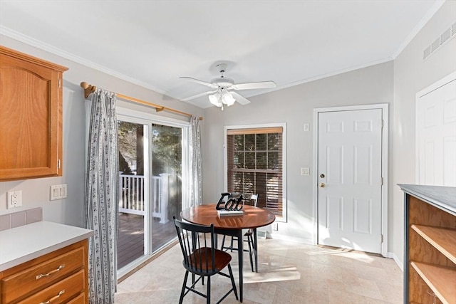 dining space featuring ornamental molding and ceiling fan