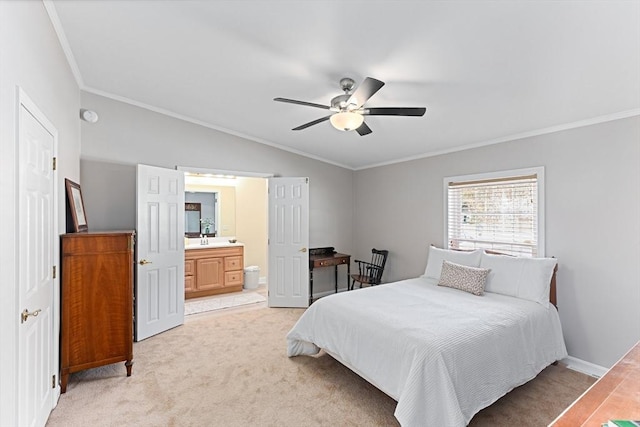 carpeted bedroom with sink, ornamental molding, ceiling fan, and ensuite bathroom