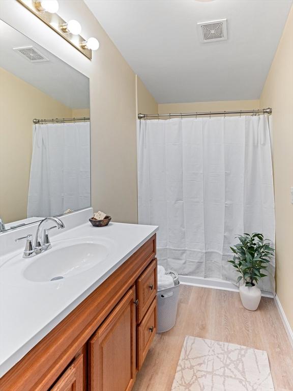 bathroom with vanity, hardwood / wood-style floors, and toilet