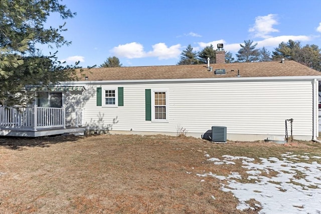 back of house with cooling unit, a yard, and a deck