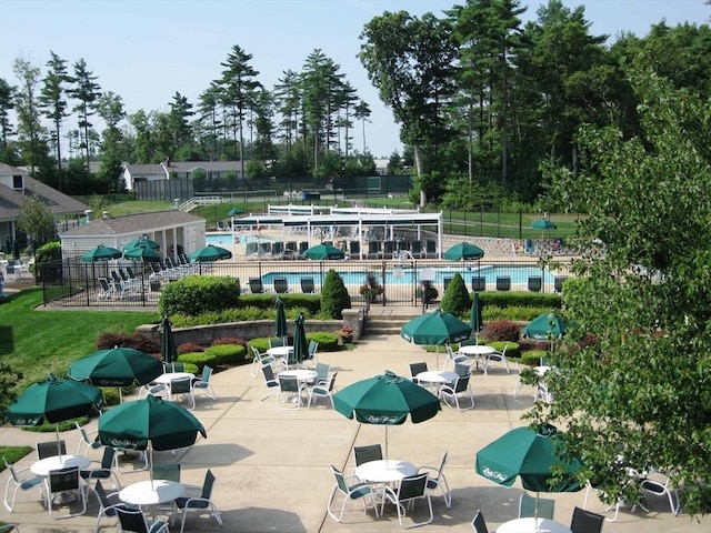 view of property's community with a pool and a patio area