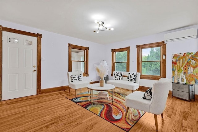 38 Main St, Acton, MA 01720 - living room featuring an AC wall unit, wood finished floors, and baseboards