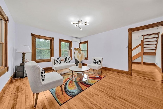 38 Main St, Acton, MA 01720 - living room featuring a chandelier, light wood-style floors, baseboards, and stairs