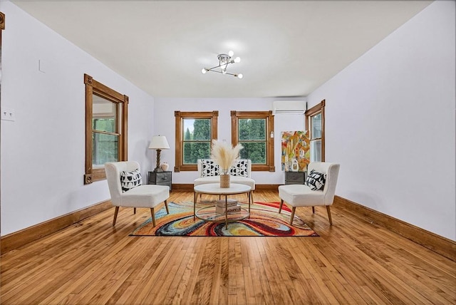 38 Main St, Acton, MA 01720 - living area featuring a wall mounted AC, hardwood / wood-style flooring, a chandelier, and baseboards
