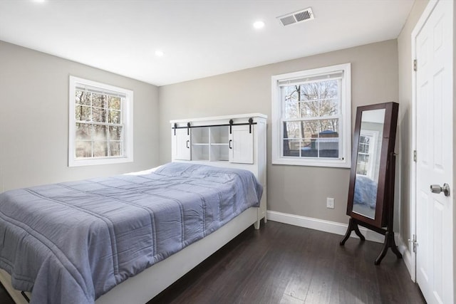 bedroom with recessed lighting, dark wood-style floors, visible vents, and baseboards