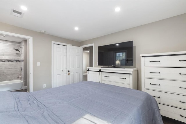 bedroom with recessed lighting, visible vents, and ensuite bathroom