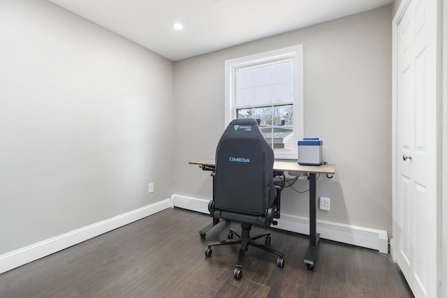 office space featuring baseboards, baseboard heating, and wood finished floors