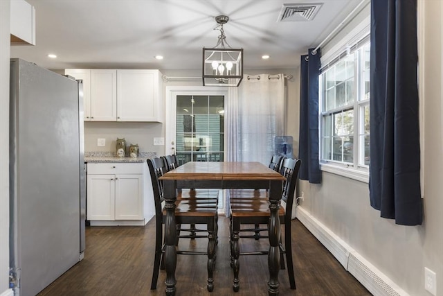 dining area with a chandelier, visible vents, baseboards, and dark wood-style flooring