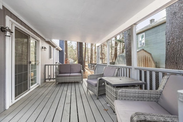 wooden deck with an outdoor living space