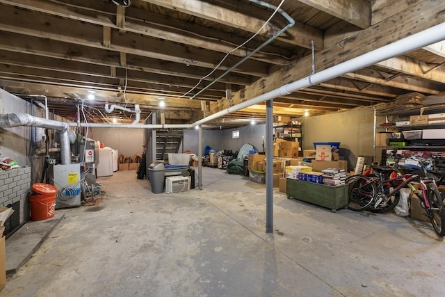 unfinished below grade area with washer and clothes dryer