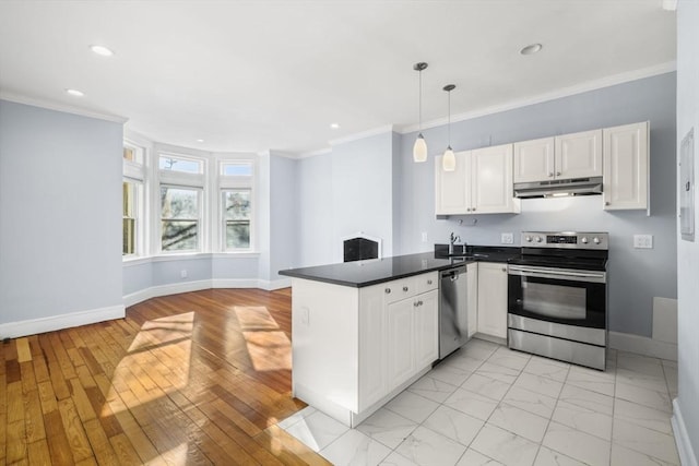 kitchen featuring stainless steel appliances, white cabinetry, pendant lighting, and kitchen peninsula