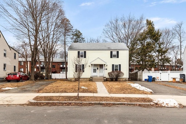 view of front of property with aphalt driveway and fence