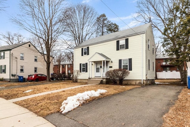 colonial house featuring aphalt driveway