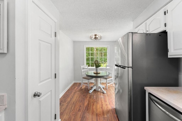 2 Colonial Dr Unit 2, Norton, MA 02766 - kitchen with appliances with stainless steel finishes, white cabinetry, dark wood finished floors, a textured ceiling, and light countertops