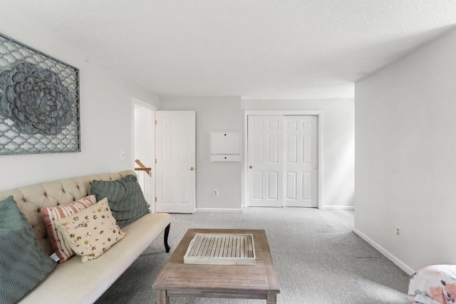 2 Colonial Dr Unit 2, Norton, MA 02766 - carpeted living area featuring baseboards and a textured ceiling