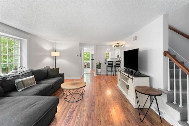 2 Colonial Dr Unit 2, Norton, MA 02766 - living area with a textured ceiling, wood finished floors, and stairs
