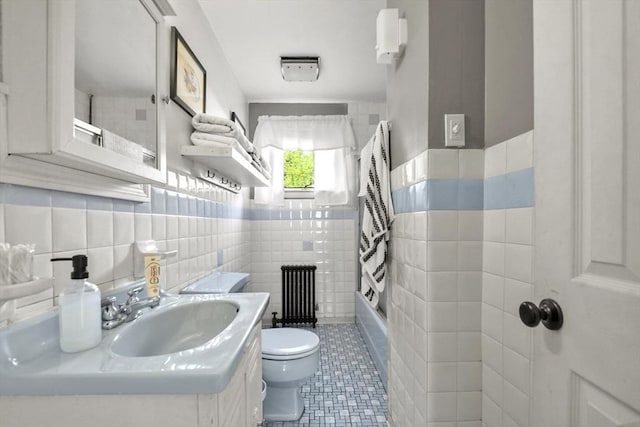 619 Crescent St, Brockton, MA 02302 - full bathroom featuring tile walls, radiator heating unit, vanity, tile patterned floors, and shower / bath combination with curtain