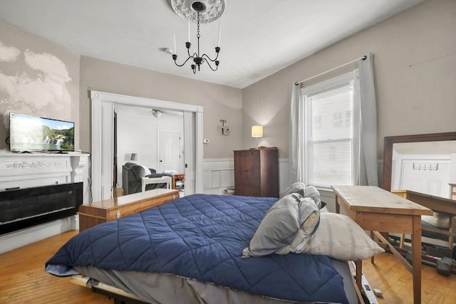 619 Crescent St, Brockton, MA 02302 - bedroom featuring wood finished floors, a chandelier, and a wainscoted wall