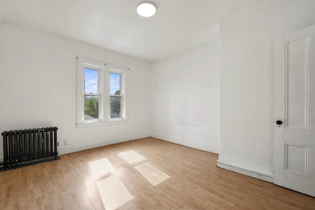 619 Crescent St, Brockton, MA 02302 - empty room featuring radiator heating unit and wood finished floors