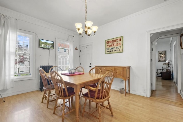 619 Crescent St, Brockton, MA 02302 - dining room with light wood-type flooring, a chandelier, healthy amount of natural light, and crown molding
