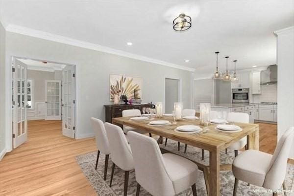 dining space featuring french doors, light wood-type flooring, and ornamental molding