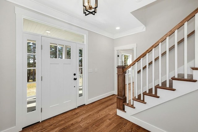 foyer entrance with hardwood / wood-style flooring and a notable chandelier