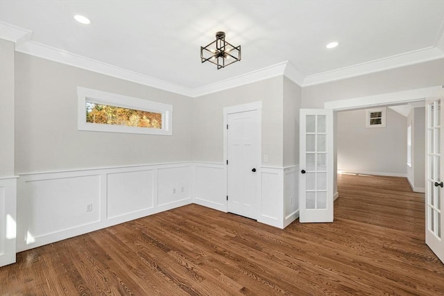 empty room featuring french doors, ornamental molding, and a notable chandelier