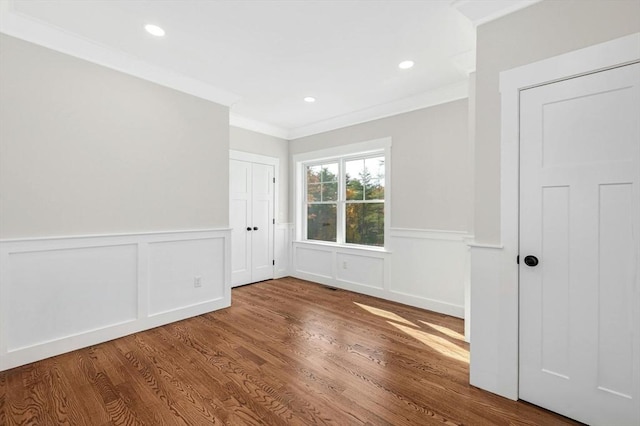 spare room with hardwood / wood-style floors and ornamental molding