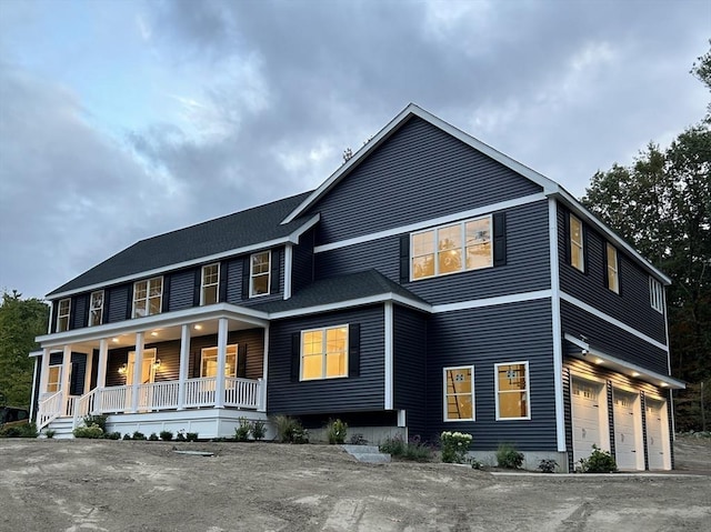 view of front facade with a porch and a garage