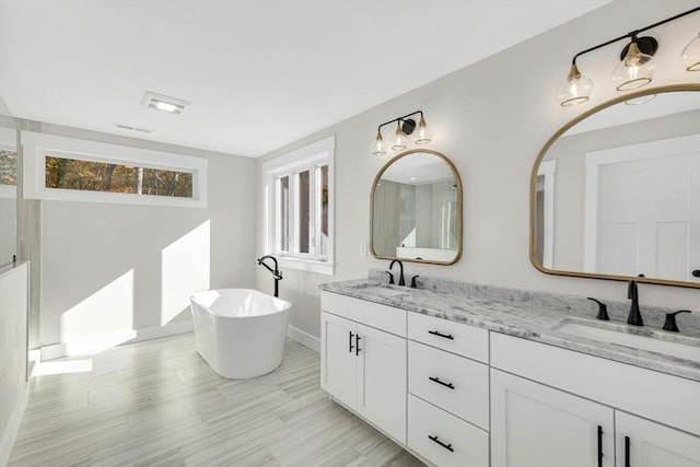 bathroom with vanity and a tub to relax in