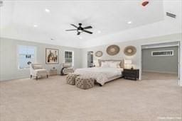 bedroom featuring ceiling fan and a raised ceiling