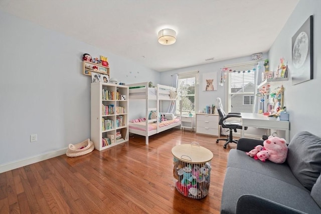bedroom with baseboards and wood finished floors